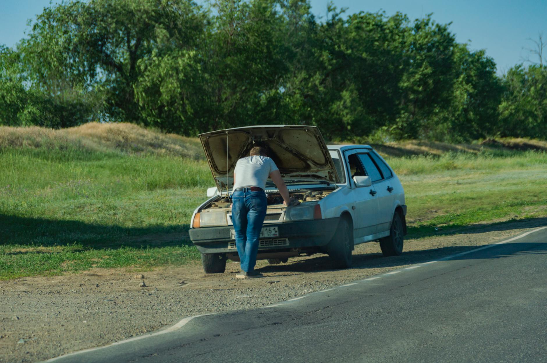 a man having car problems on the roadside